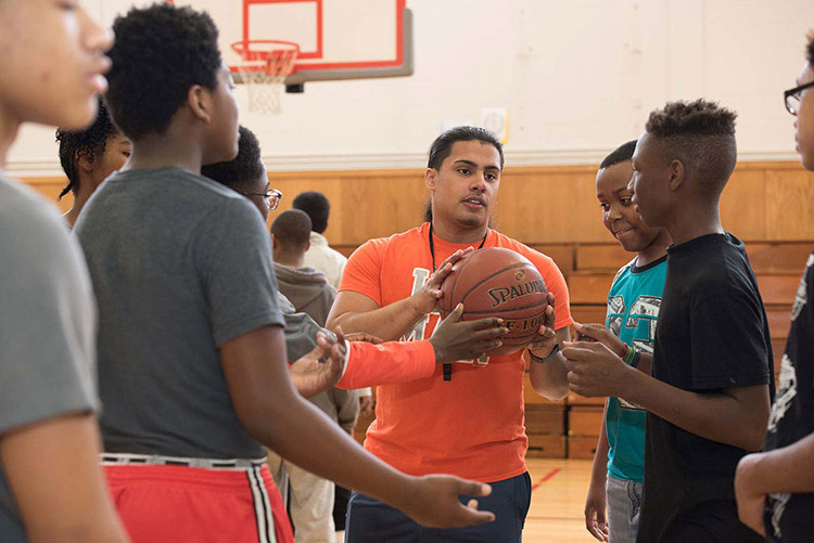 physical education teacher instructing young students