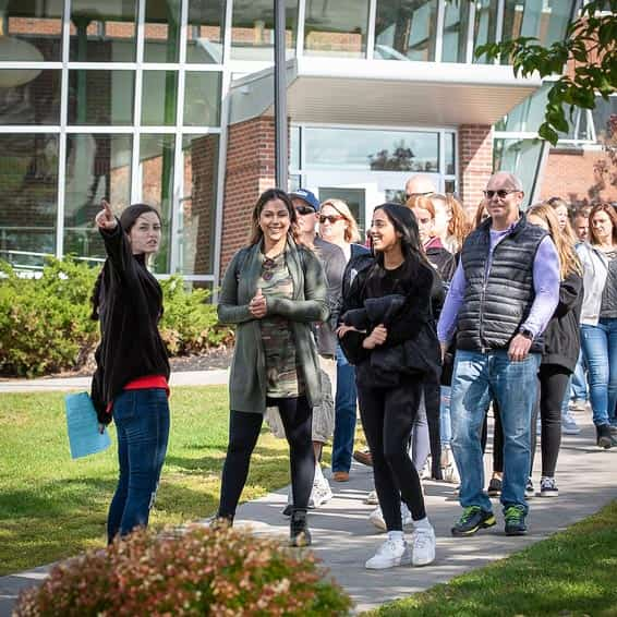 Tour guide showing families around campus