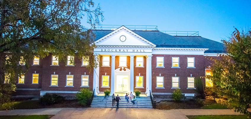 Students on Brockway Hall steps at night