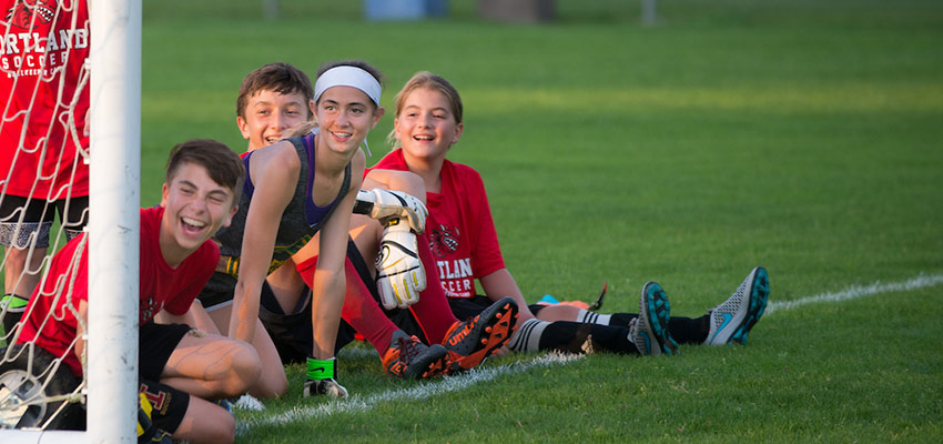 Children laughing at a soccer camp