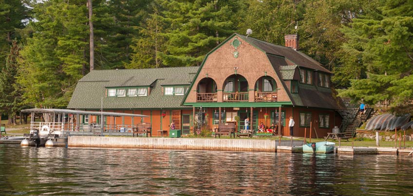 Antler's building reflecting in Raquette Lake