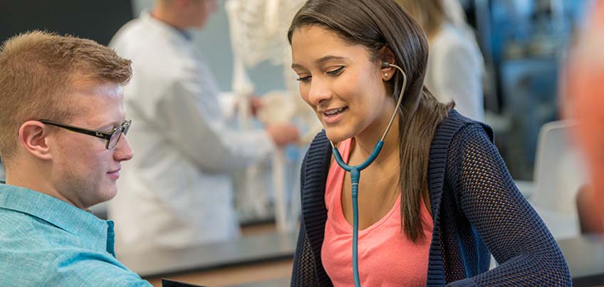 Pre-med club members take blood pressure readings