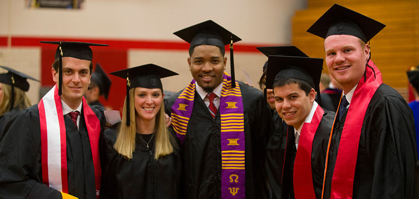 Graduate students smile after their ceremony