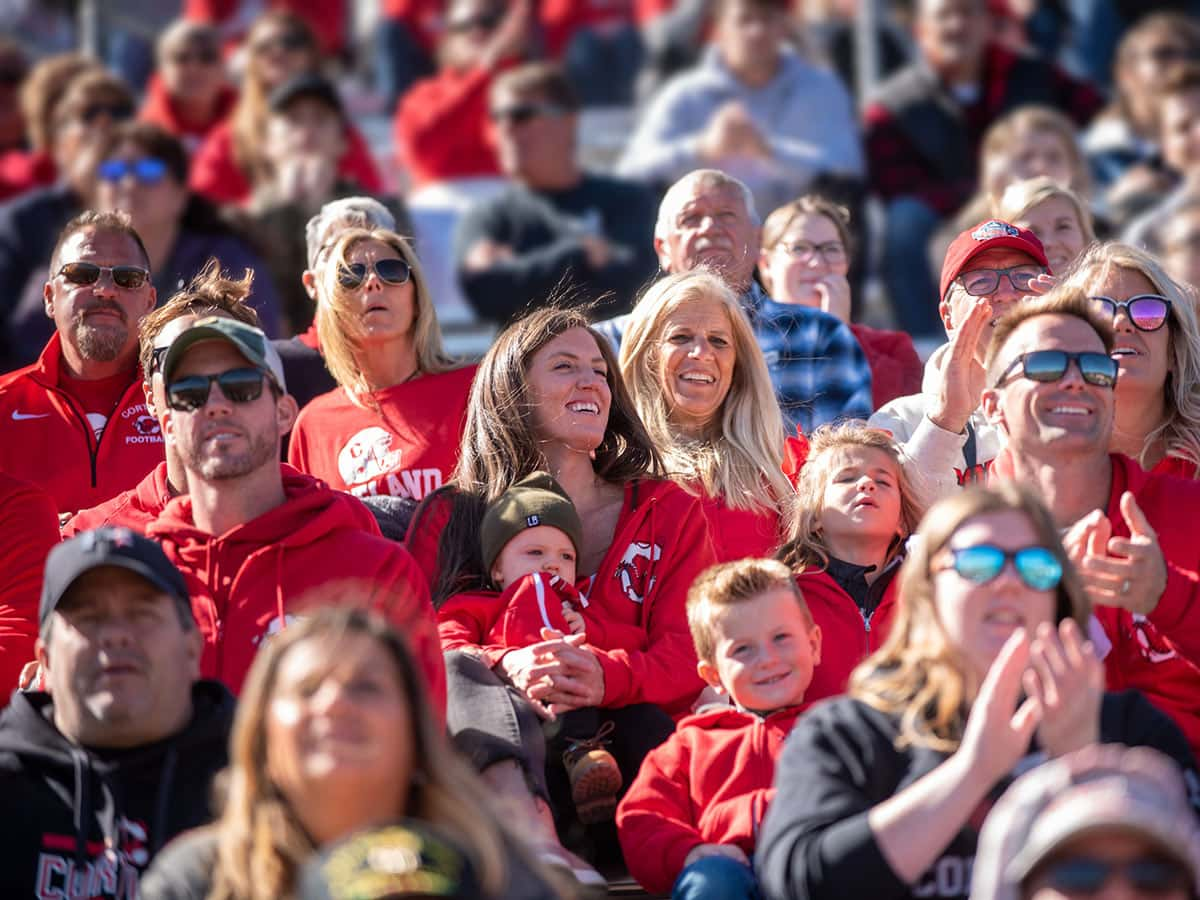 Family members cheering on the football