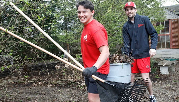 students cleaning up a yard for the Big Event