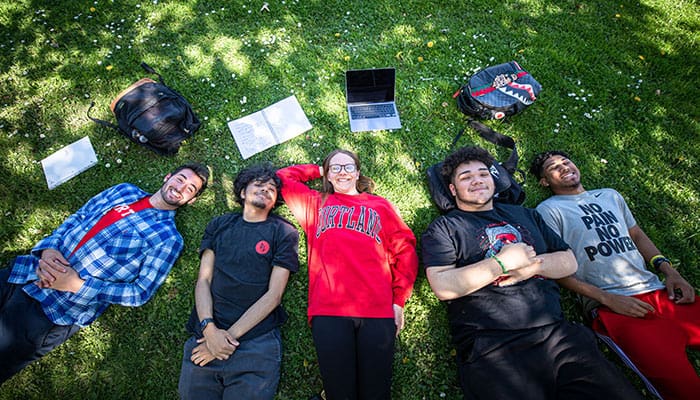 Students lying in the grass