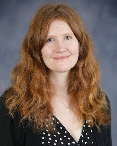 white woman in dress and sweater