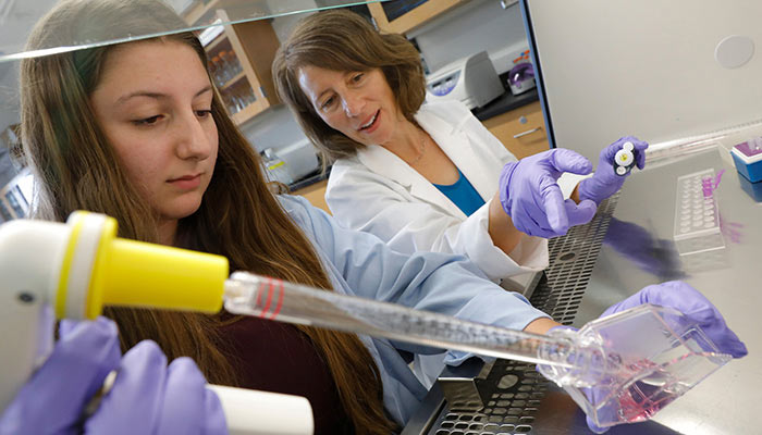 Student and professor in a science lab