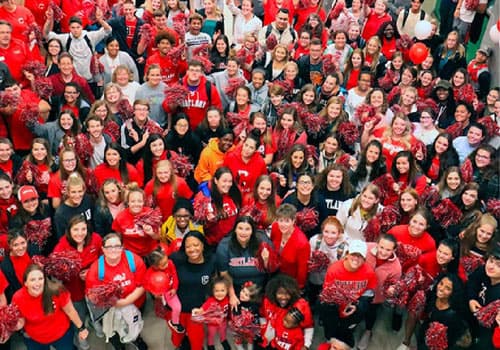 crowd of students, faculty and staff wearing red