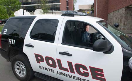 A SUNY Cortland police office inside a police vehicle.