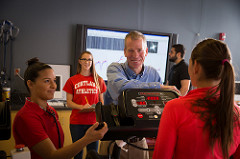 Professor and students interacting in a learning space. 